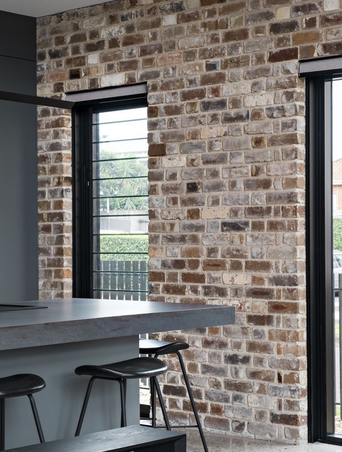 The recycled brick facade is carried through one wall of the interior.