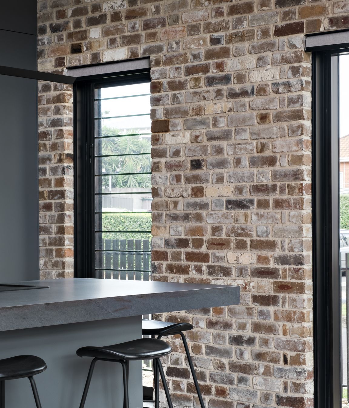 The recycled brick facade is carried through one wall of the interior.