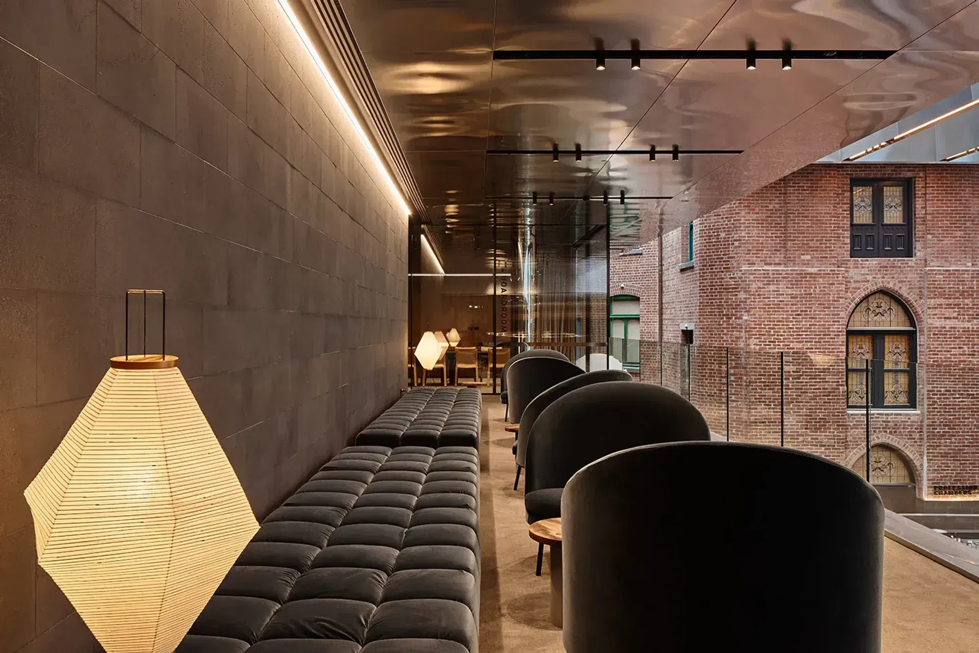 An anti-space off the boardroom with a B&B Italia Tufty-Time sofa and Jim armchairs by Arflex, offset by the textural warmth of the surrounding heritage buildings.