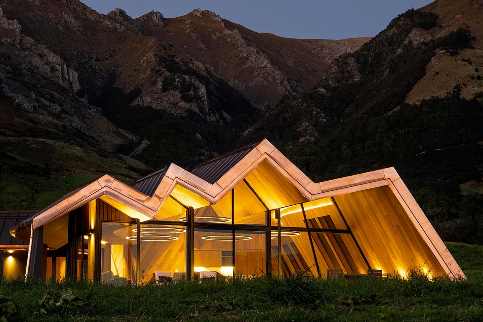 The roof imitates the jagged form of the surrounding mountain ranges, taking inspiration from Zaha Hadid's Riverside Museum.