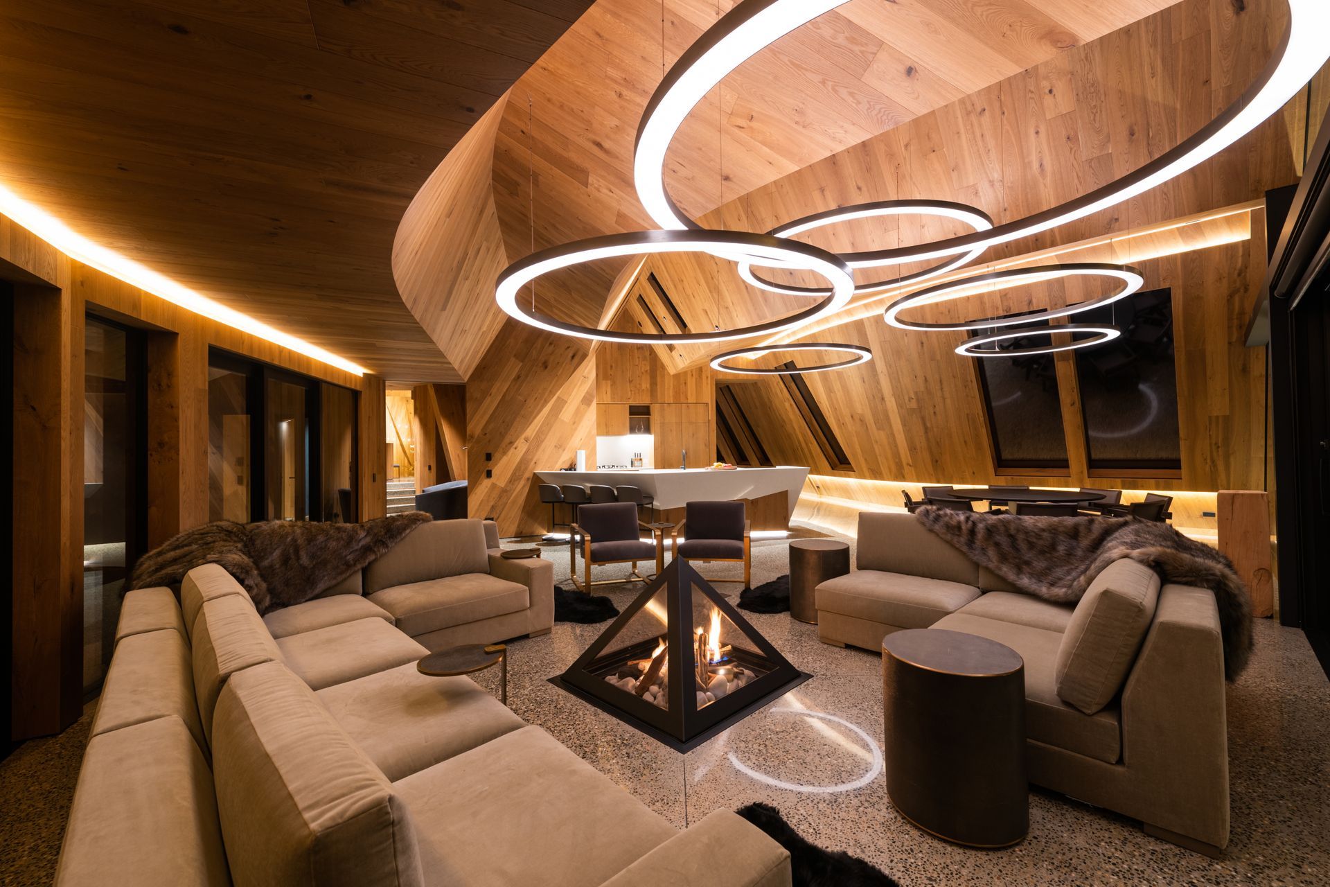 A pyramid fireplace is a focal point in the lounge, referencing the copper peaks on the roof.