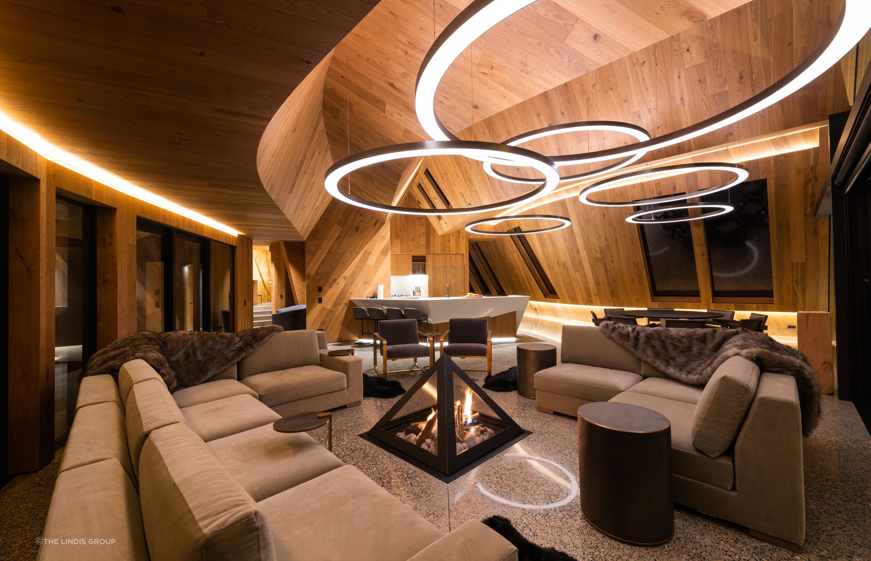 A pyramid fireplace is a focal point in the lounge, referencing the copper peaks on the roof.