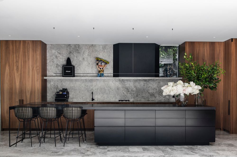 The kitchen island with its porcelain benchtop and open end provides an easy place to feed children.