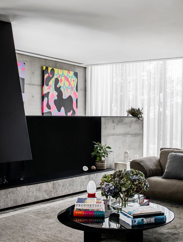 A gas fireplace is built into a pony wall in the living space, providing a cosy spot to gather.