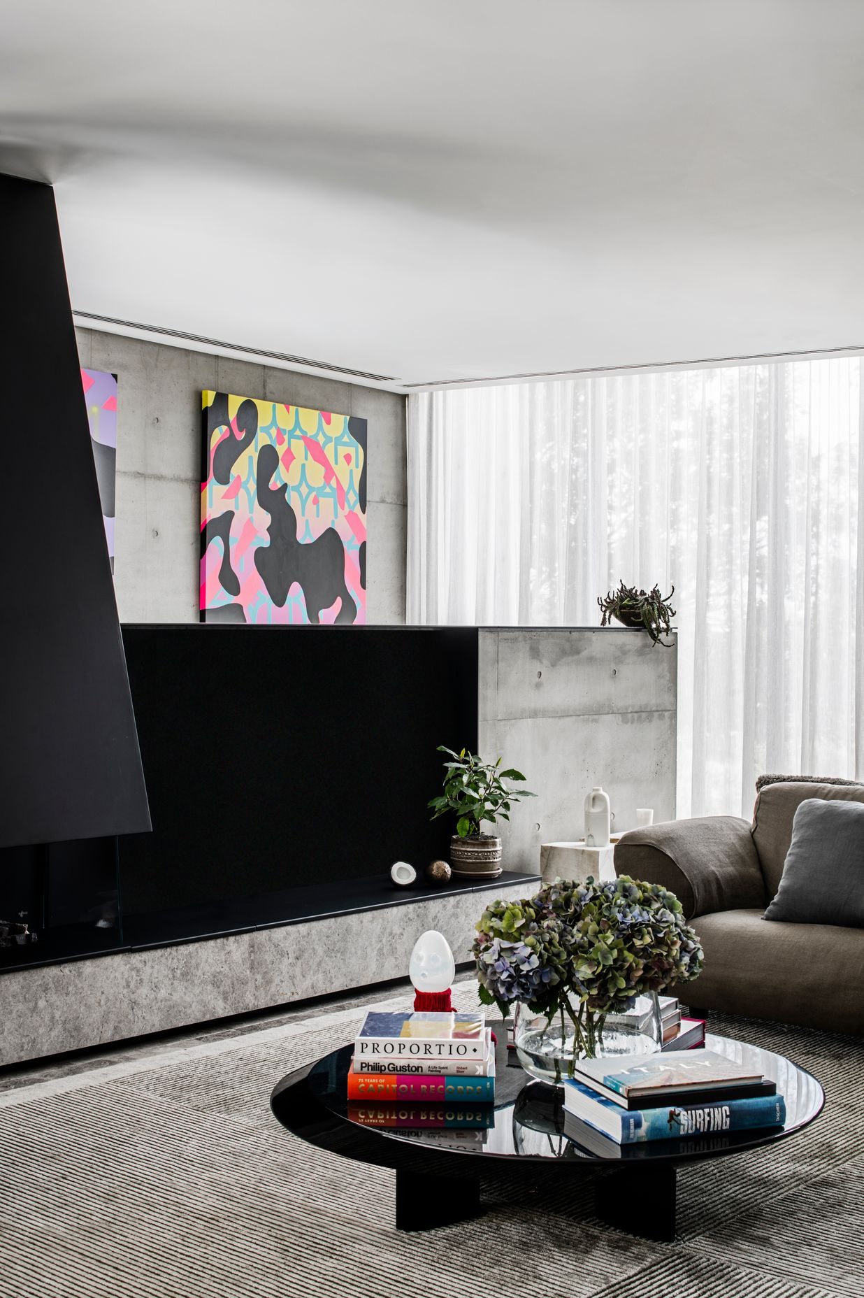 A gas fireplace is built into a pony wall in the living space, providing a cosy spot to gather.