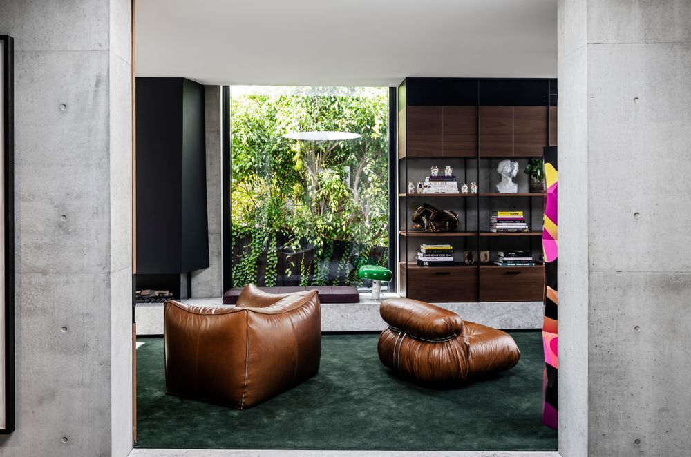 The dark green carpet and rich walnut veneer draws the outside into the lounge.