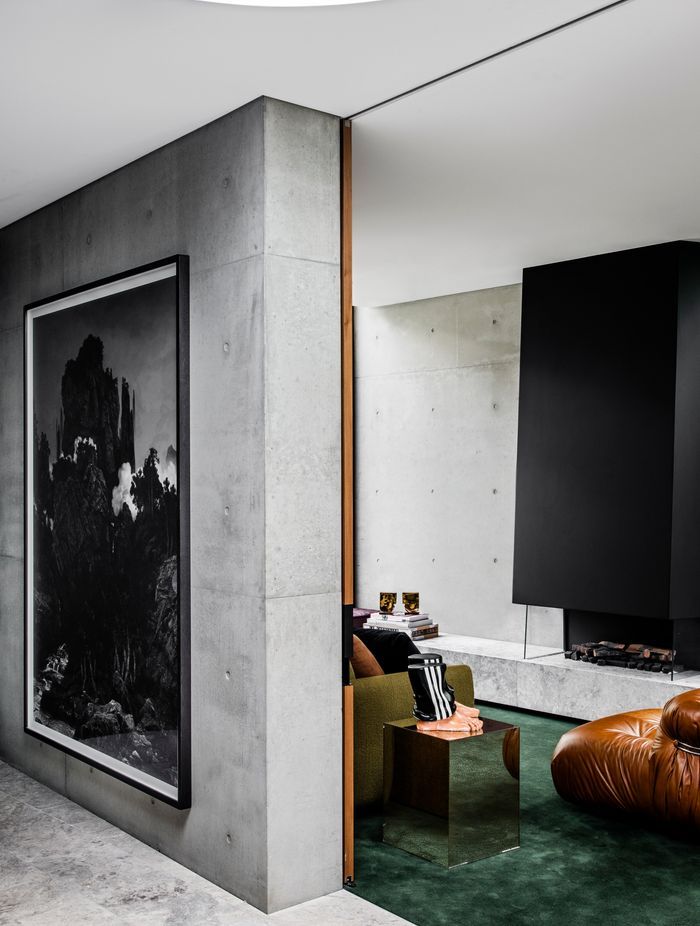 Pale concrete tones paired with biophilic greens ensure a serene palette throughout.