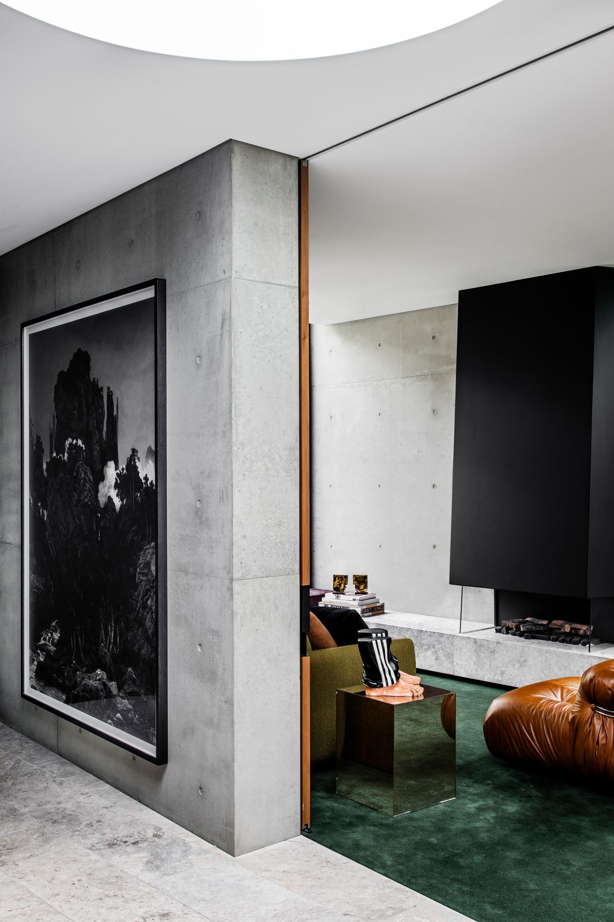 Pale concrete tones paired with biophilic greens ensure a serene palette throughout.