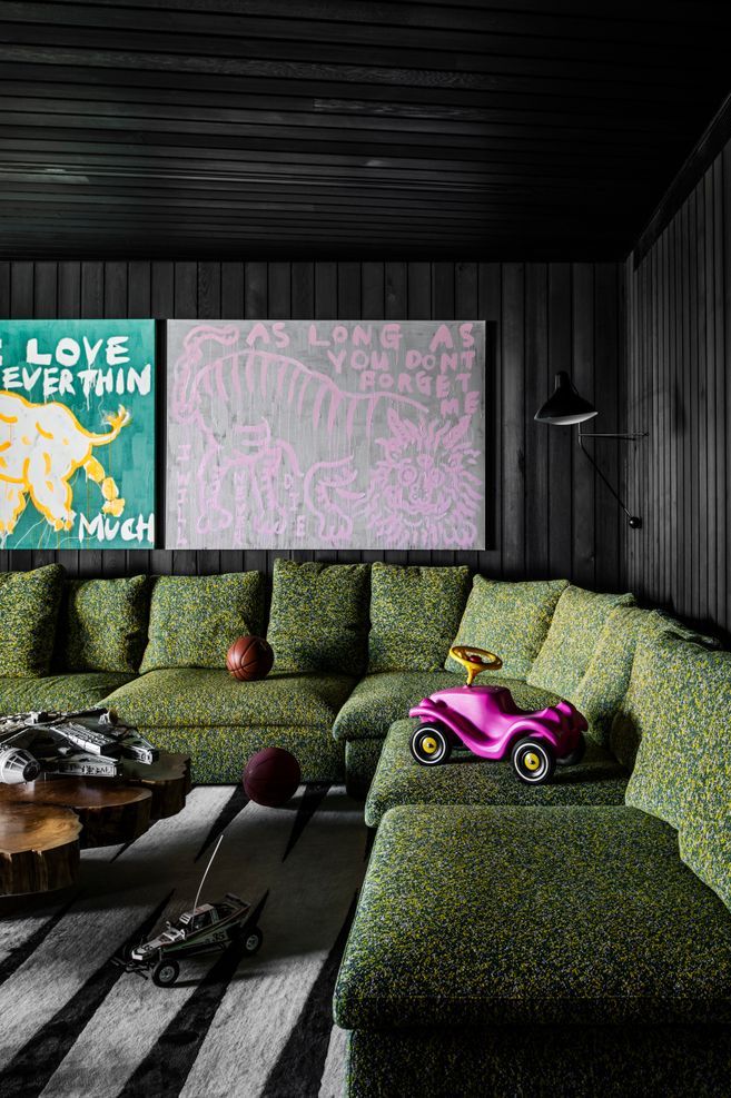 A playroom on the bottom floor features stained timber panelling and is a cosy place to retreat to.