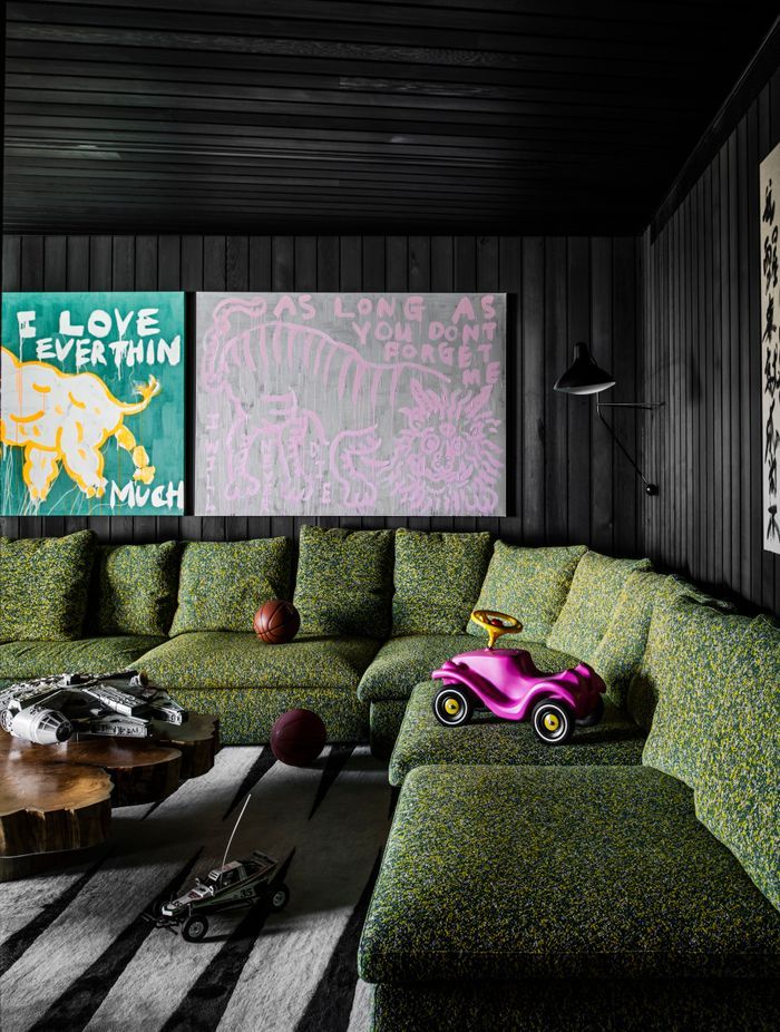 A playroom on the bottom floor features stained timber panelling and is a cosy place to retreat to.