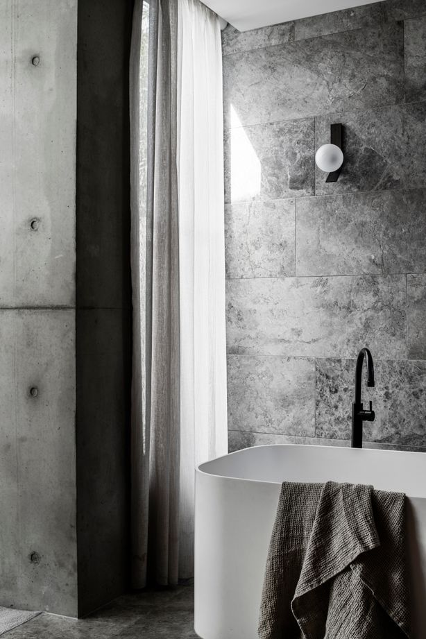 Linen drapes soften the light in a bathroom.