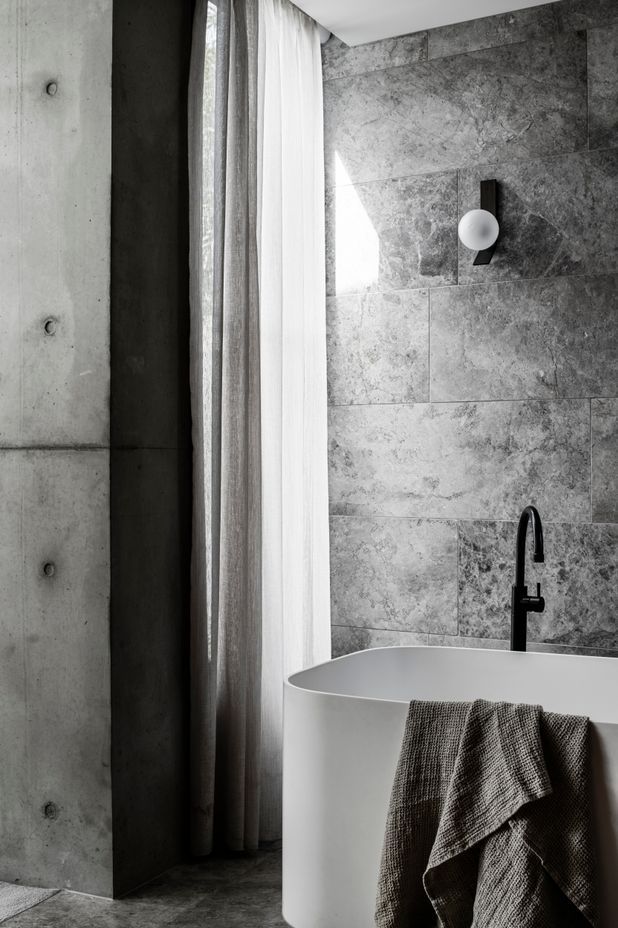 Linen drapes soften the light in a bathroom.