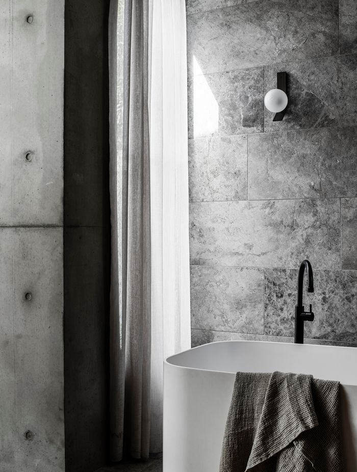 Linen drapes soften the light in a bathroom.