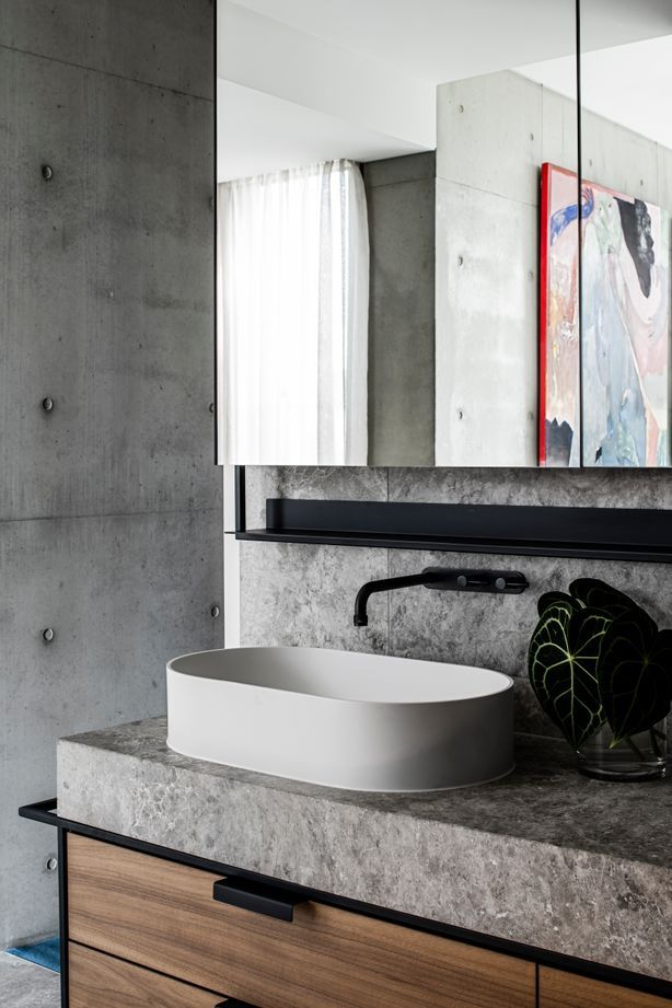 The detailing in the master ensuite integrates stone, steel and rich walnut timber veneer.