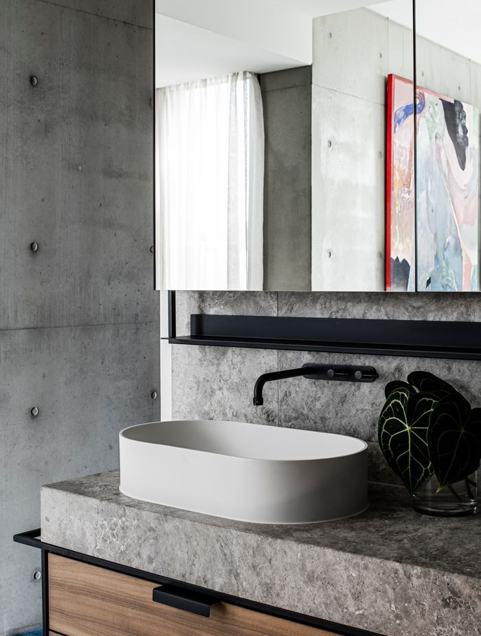 The detailing in the master ensuite integrates stone, steel and rich walnut timber veneer.