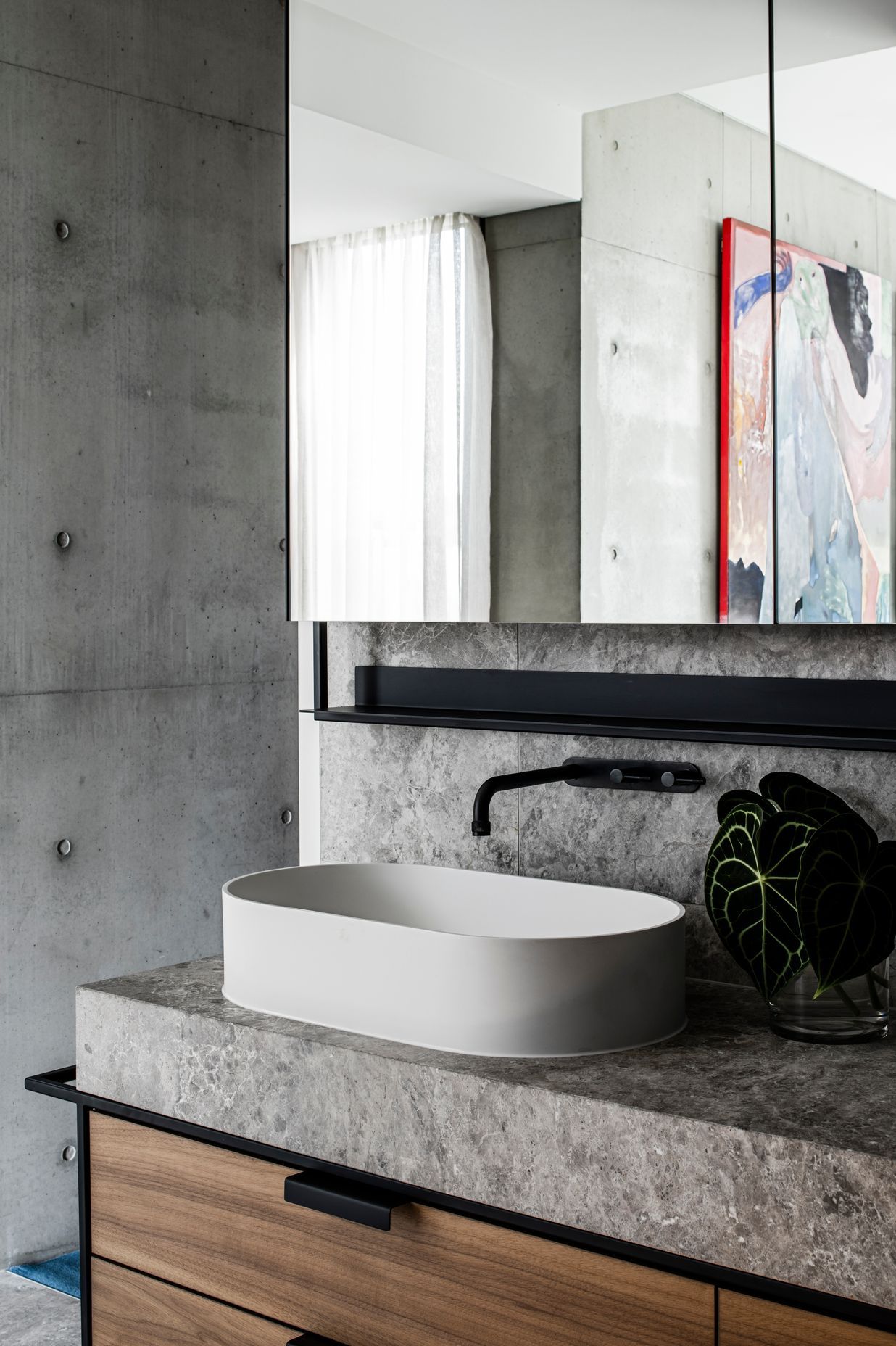 The detailing in the master ensuite integrates stone, steel and rich walnut timber veneer.
