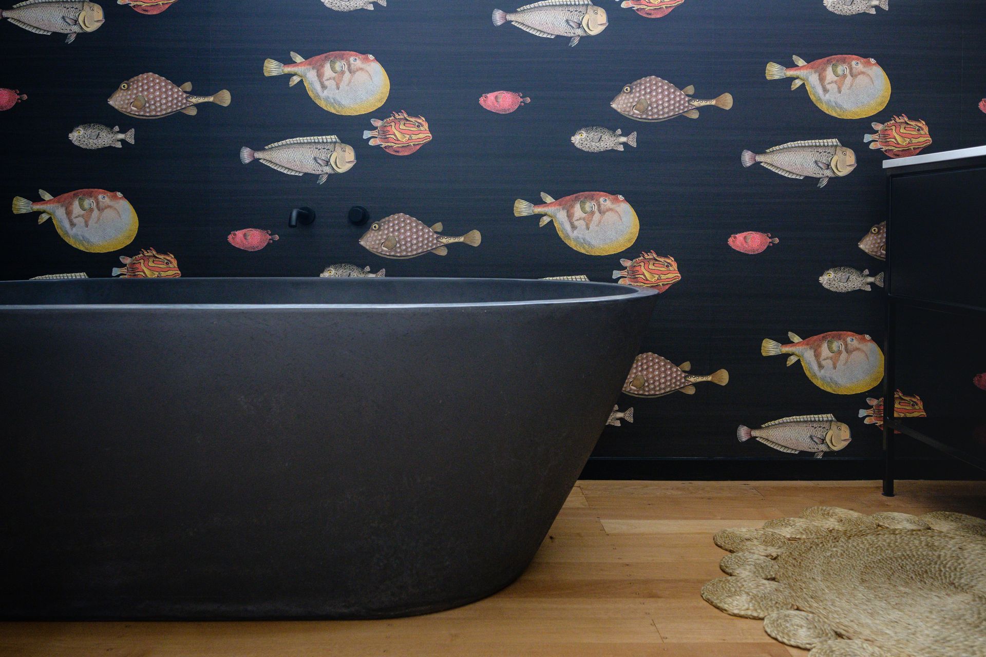 The wallpaper is Acquario by Fornasetti from Icon Radford and the bath is by Concrete Nation. Image Jay Drew