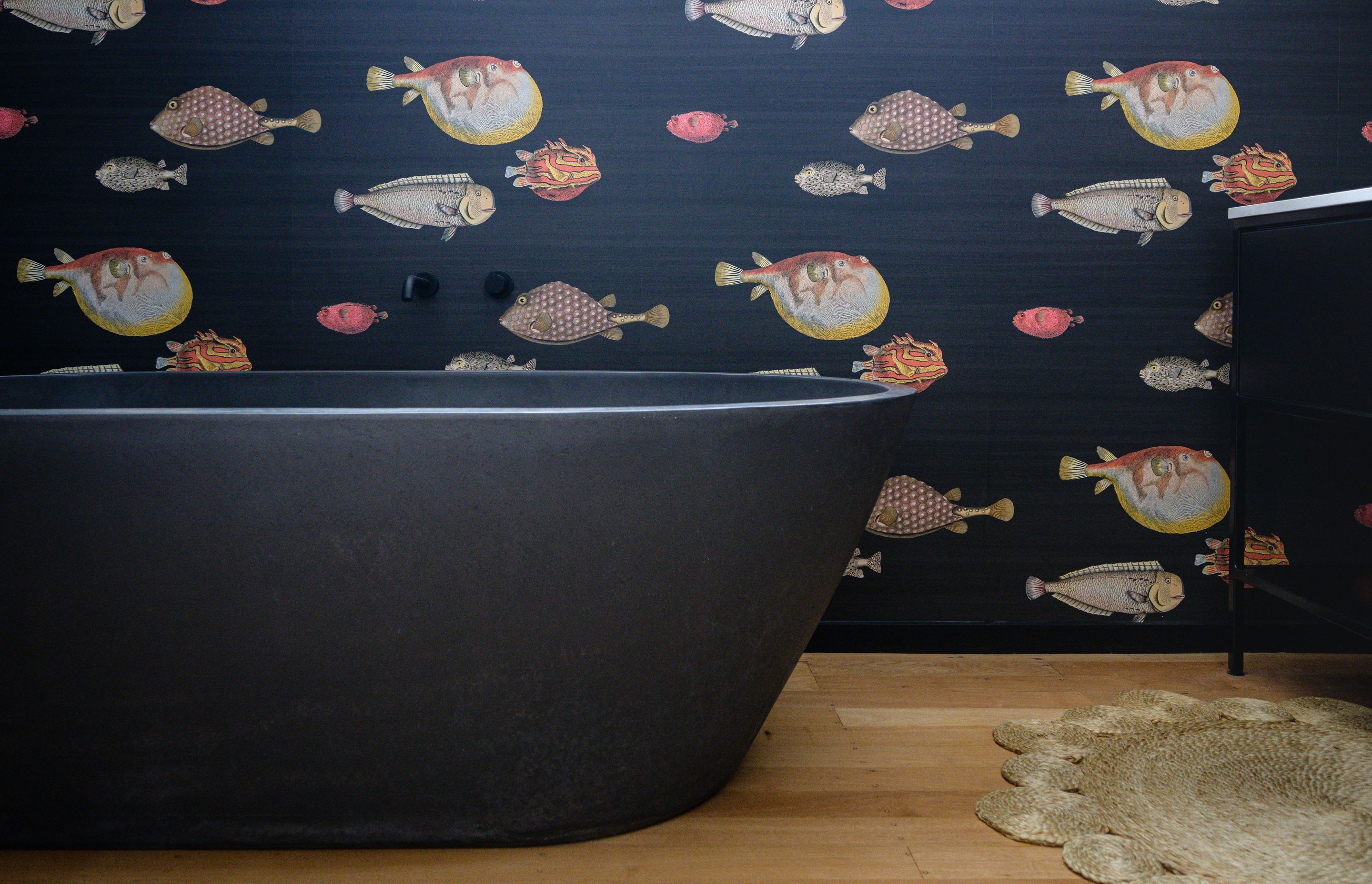 The wallpaper is Acquario by Fornasetti from Icon Radford and the bath is by Concrete Nation. Image Jay Drew