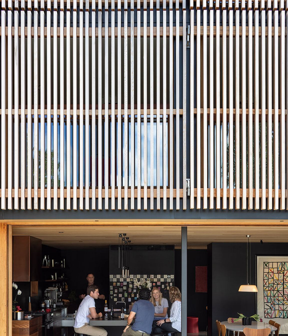 Seamless indoor-outdoor living above a dramatic facade.