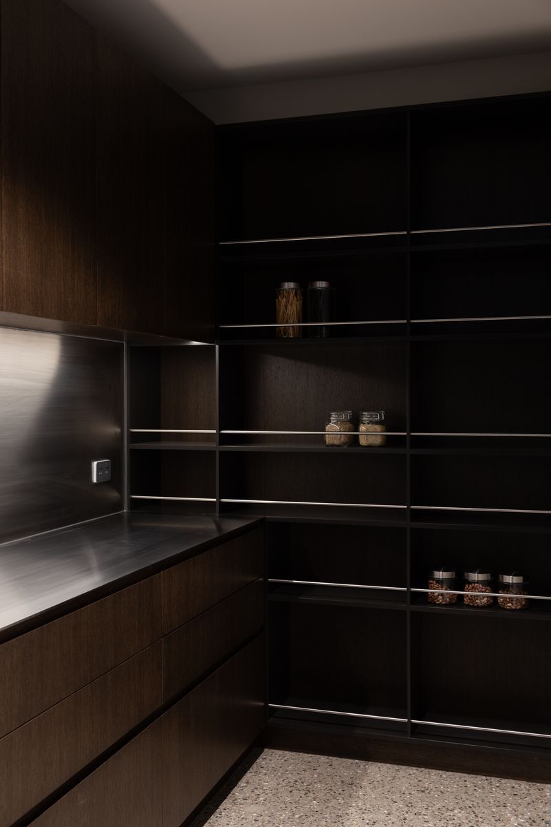 The butler’s pantry, a continuation of the chocolate brown cabinets and stainless steel benchtop | Photographer: Anna McLeod