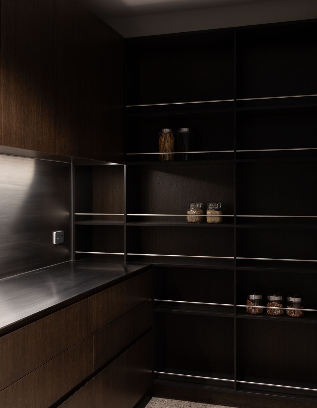 The butler’s pantry, a continuation of the chocolate brown cabinets and stainless steel benchtop | Photographer: Anna McLeod