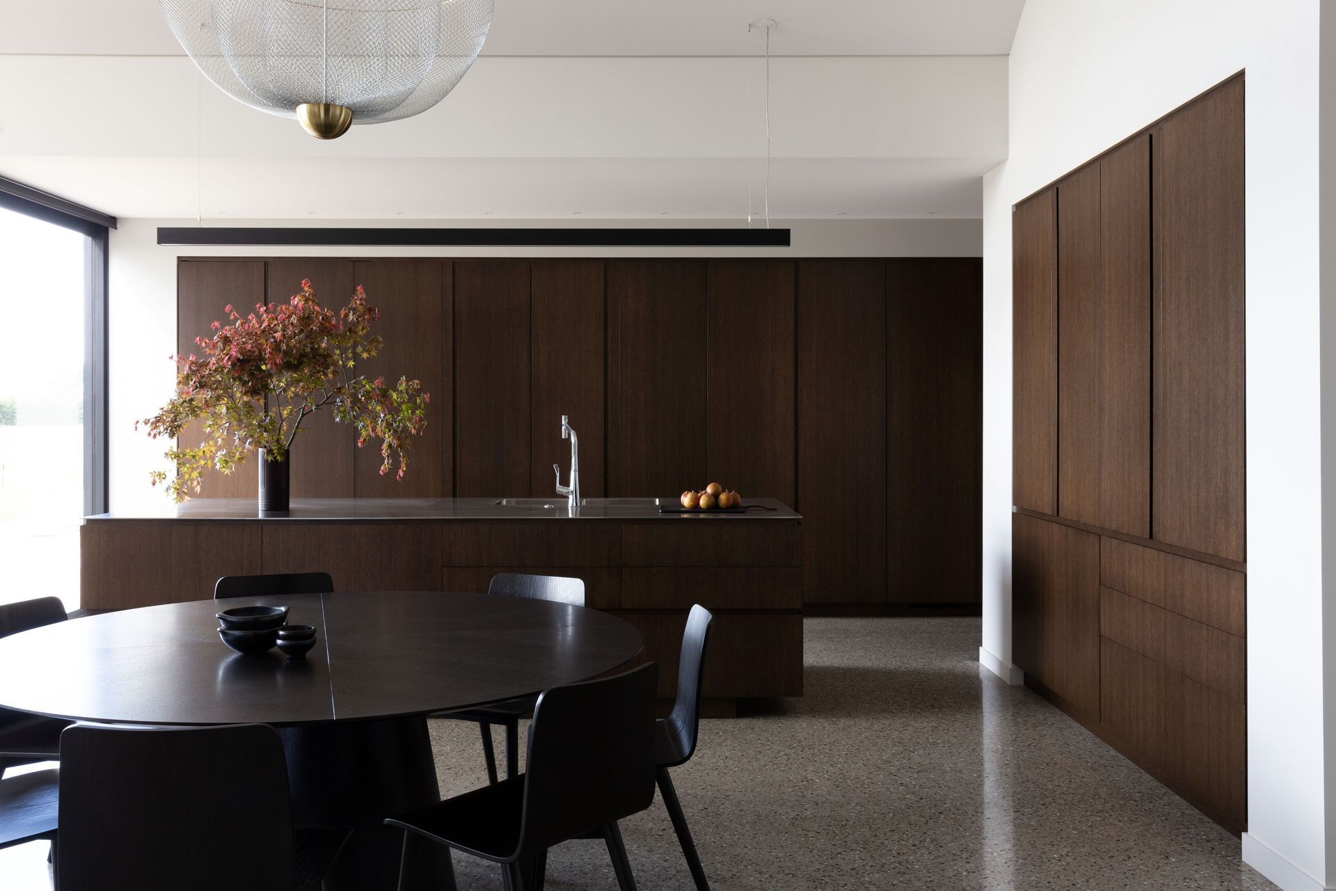 The kitchen, open spatially yet hidden away by large oak sliding doors | Photographer: Anna McLeod