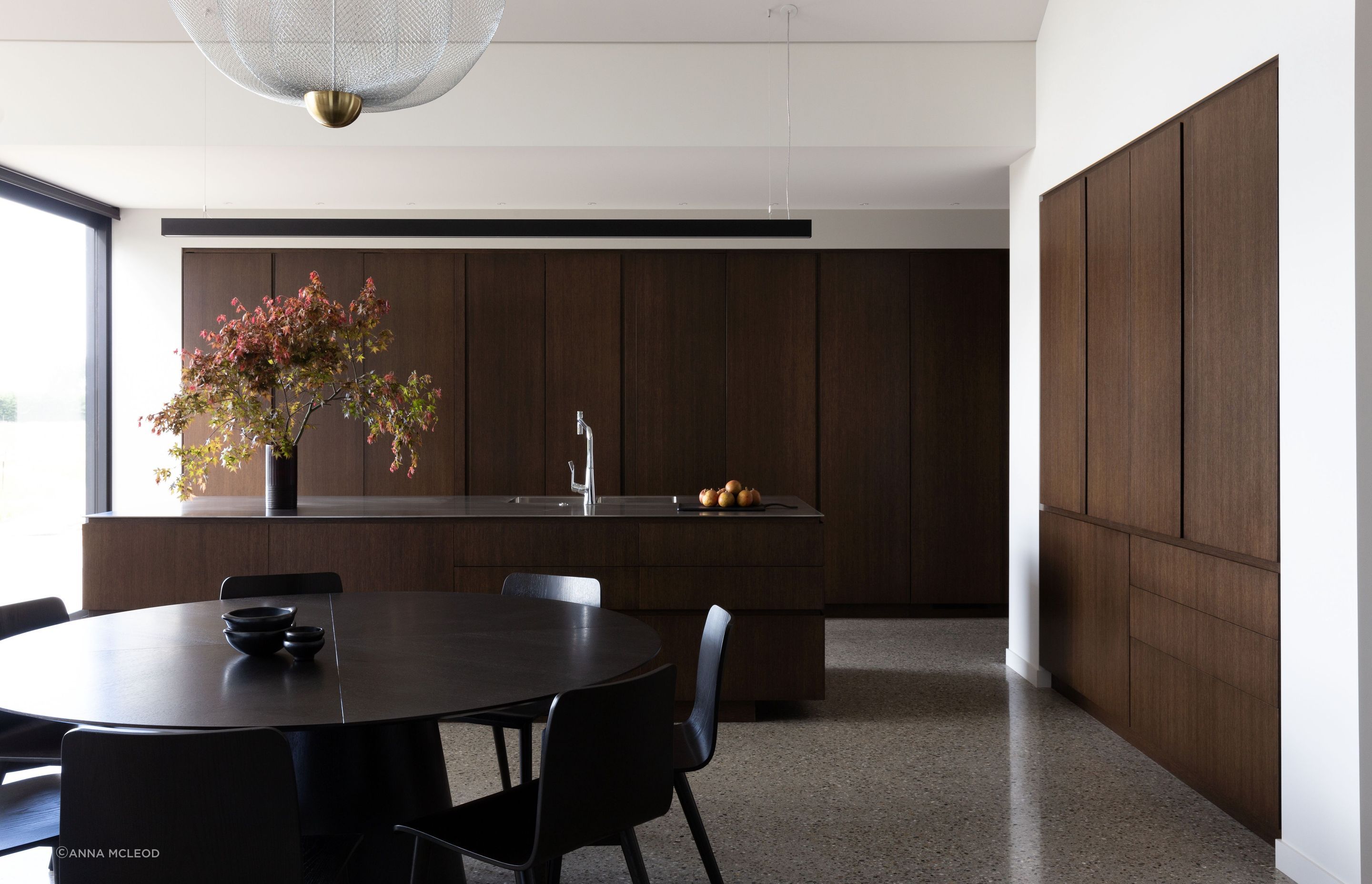 The kitchen, open spatially yet hidden away by large oak sliding doors | Photographer: Anna McLeod