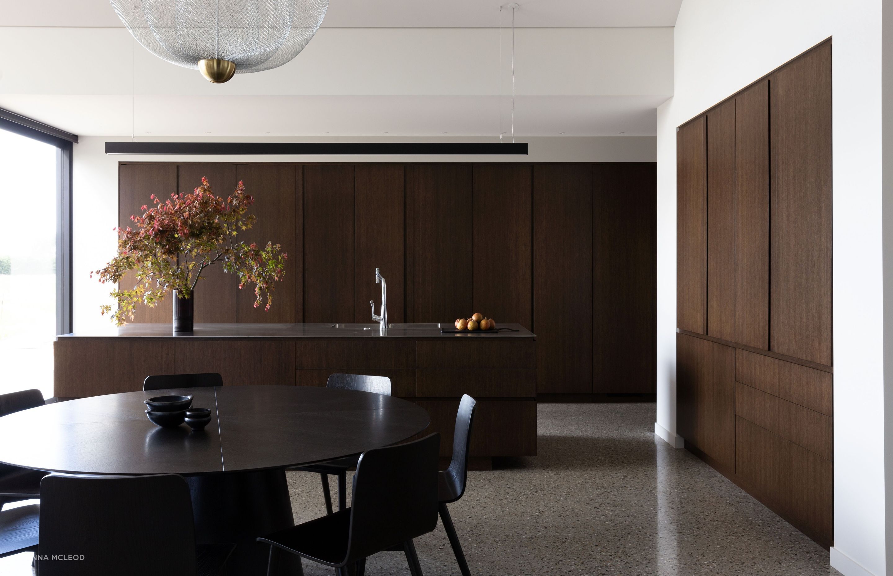 The kitchen, open spatially yet hidden away by large oak sliding doors | Photographer: Anna McLeod