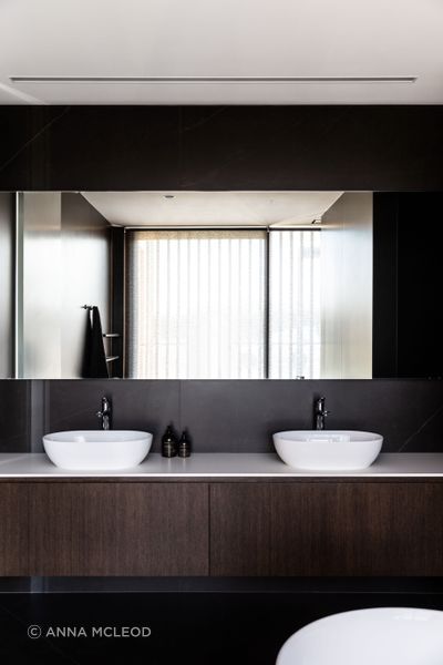 The main bathroom; expressing the same elegance and chocolate brown cabinetry as seen in the kitchen | Photographer: Anna McLeod