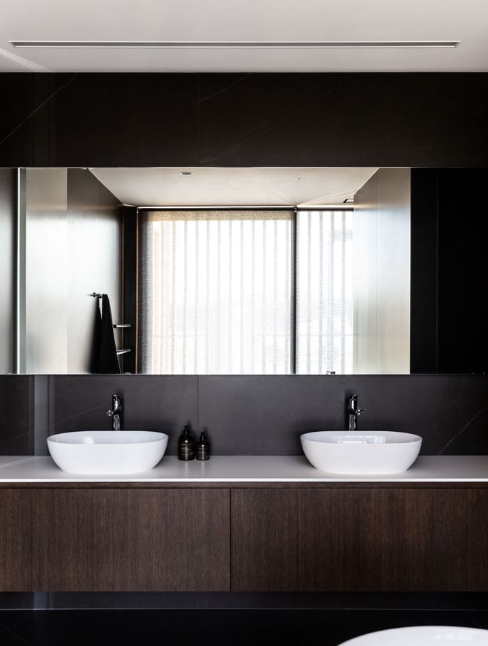 The main bathroom; expressing the same elegance and chocolate brown cabinetry as seen in the kitchen | Photographer: Anna McLeod