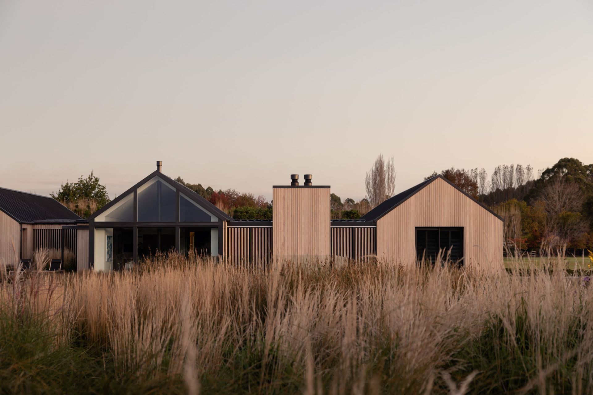 The northern elevation; heavily glazed yet still offering privacy with the option to pull across the sliding cedar screens | Photographer: Anna McLeod