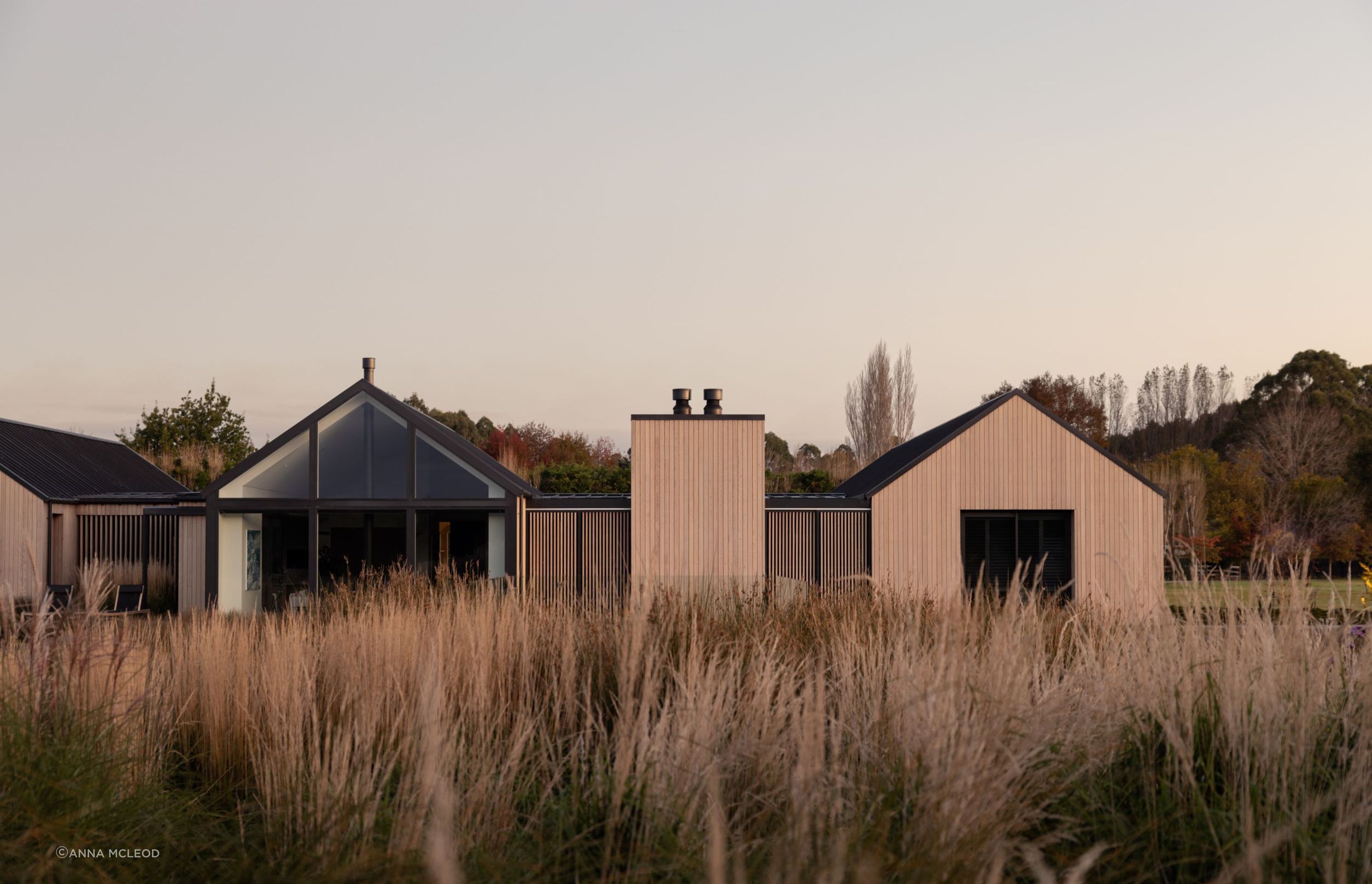 The northern elevation; heavily glazed yet still offering privacy with the option to pull across the sliding cedar screens | Photographer: Anna McLeod