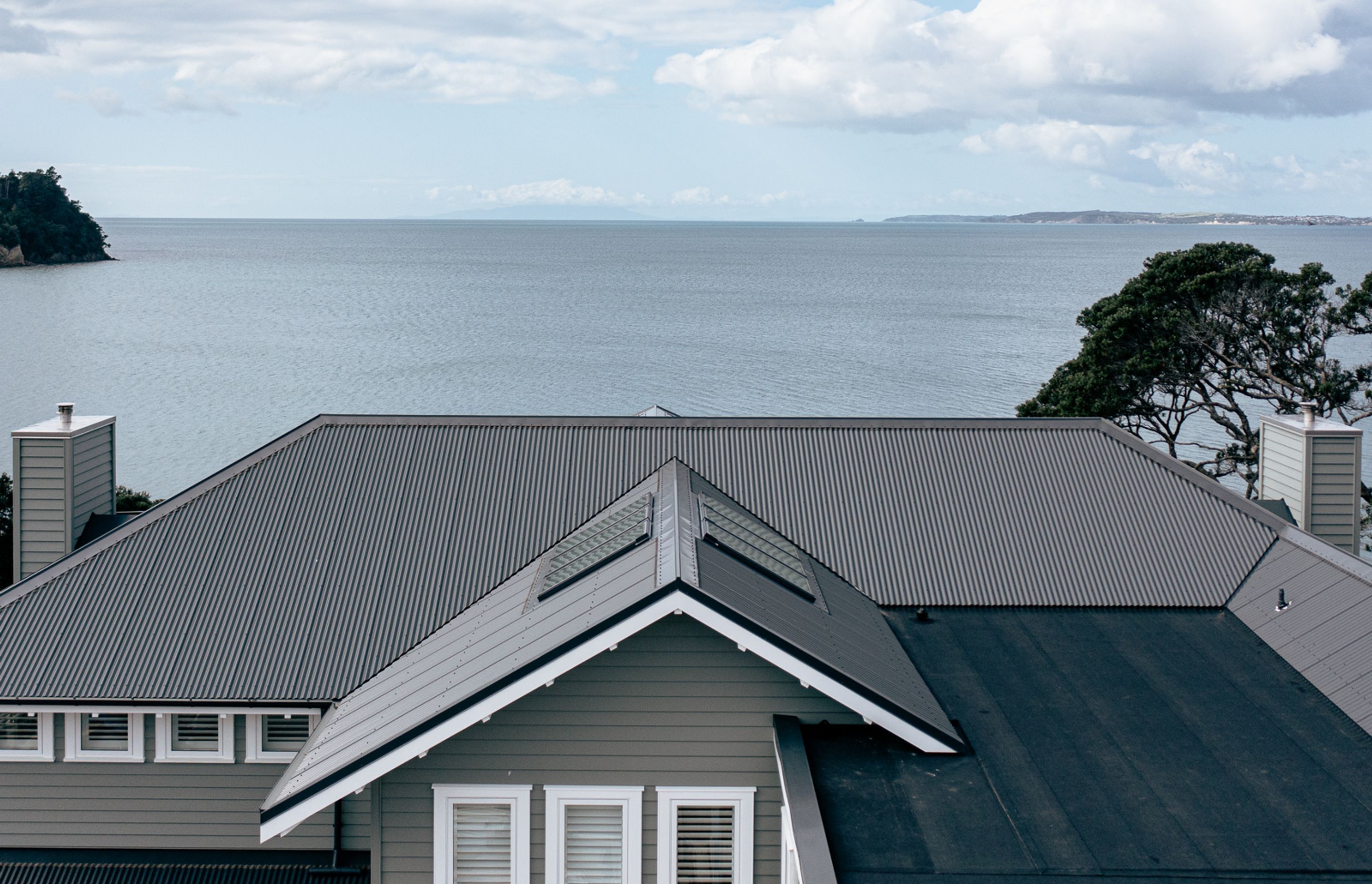 The classic hipped roof at the seaward-facing side of the home, becomes more complex at the back at the house. Zane Dykman says the "roof shout" was one of the first big milestones of the project.