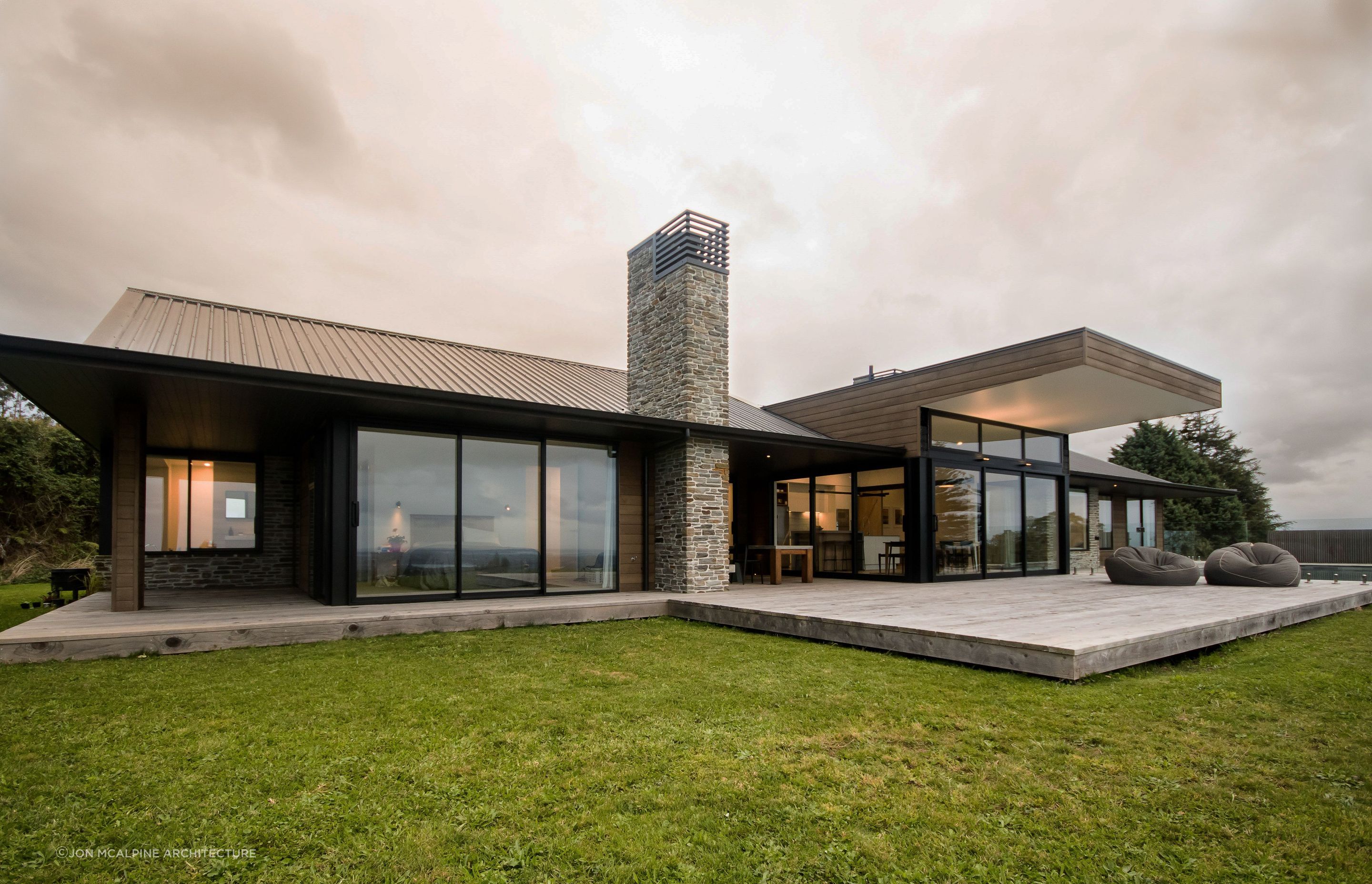 Natural materials like stone and cedar are elegantly used at Ohauiti House.