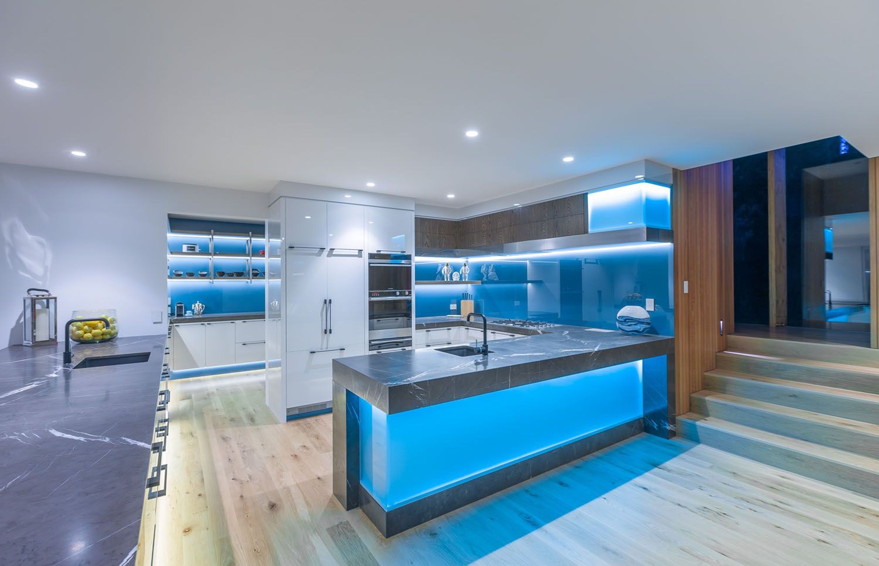 Glass used for maximum effect - splashback, island back, toekicks.  Kitchen:  Mal Corboy Design/Photography Kallan McLeod