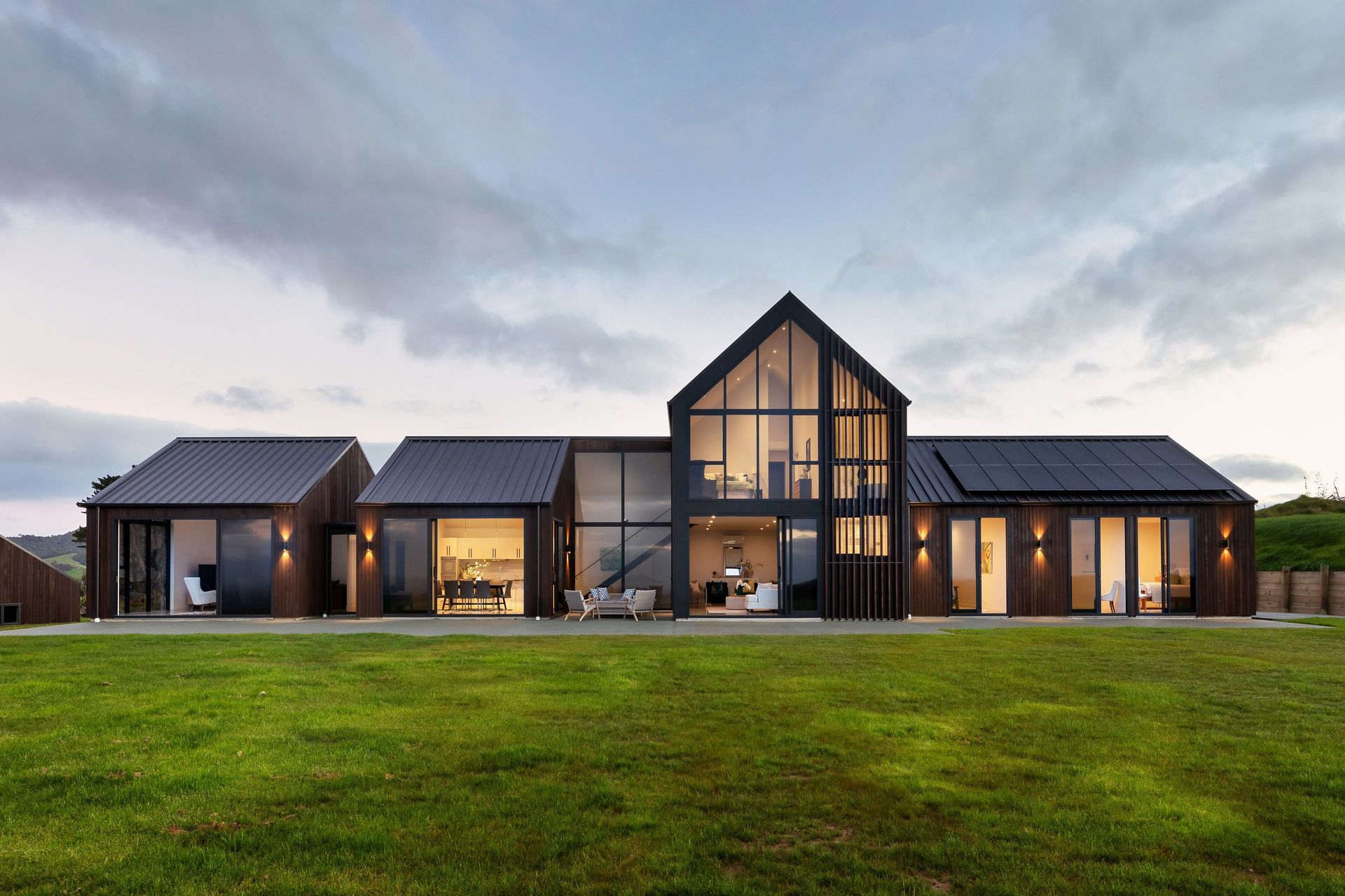 Dark stained timber, profiled metal and stunning design with this home in Pakiri — Photography: Stephen Entwisle