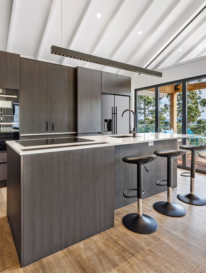 The white raked ceiling gives the kitchen a bright, spacious feel.