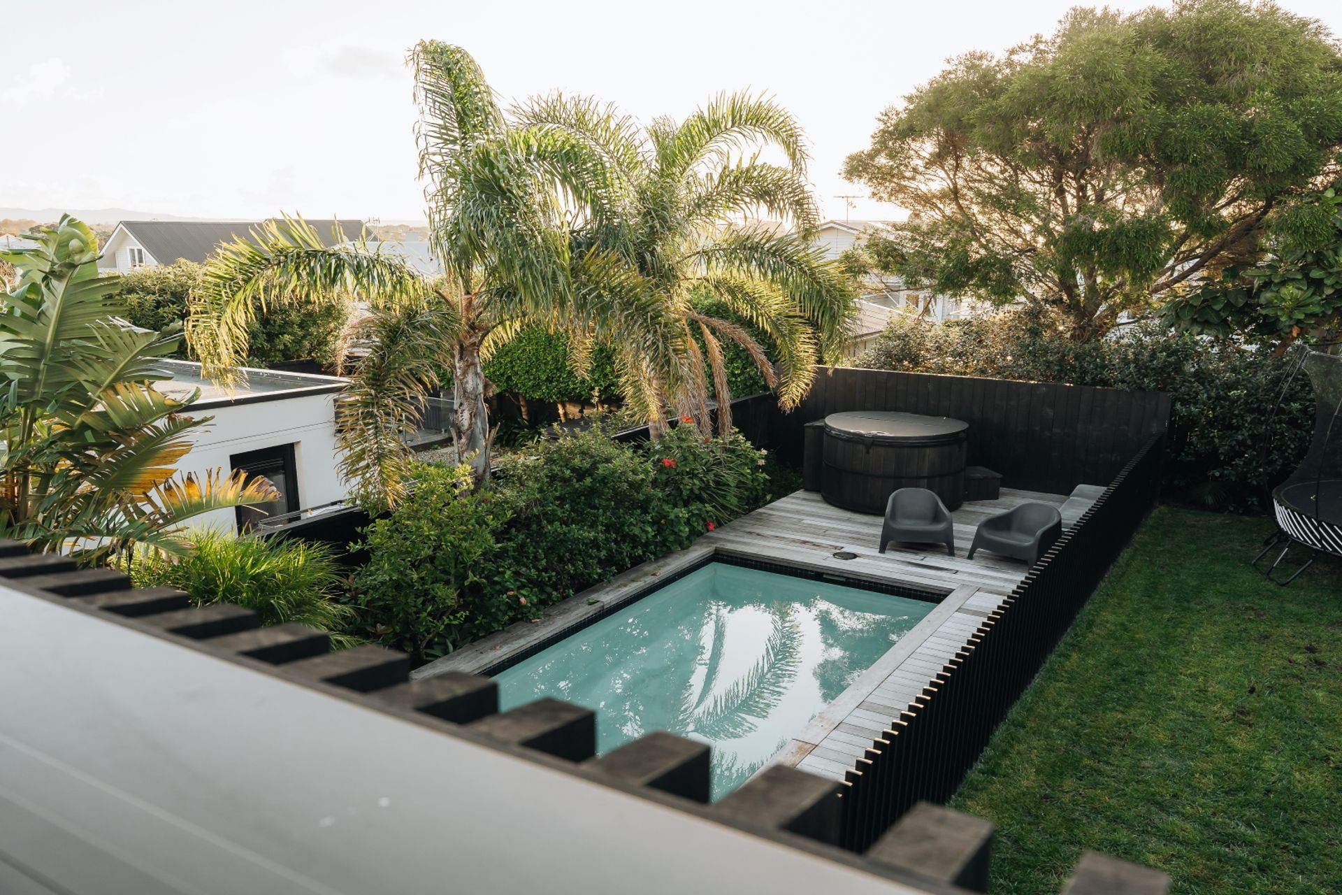 The pool fencing mimics the home's exterior cladding.