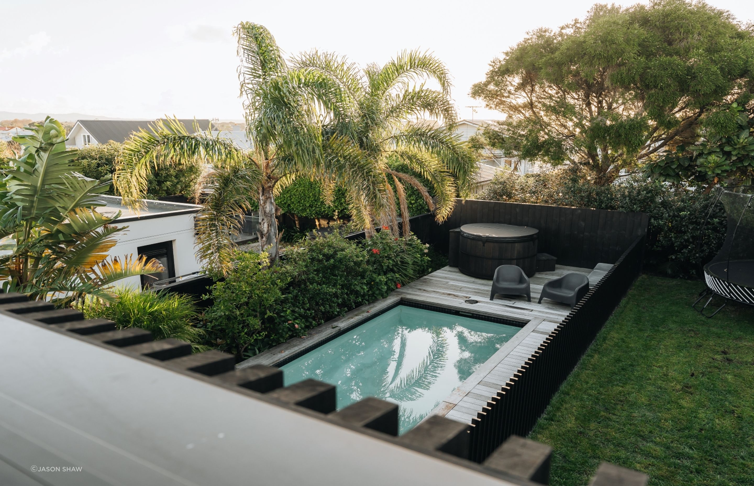 The pool fencing mimics the home's exterior cladding.