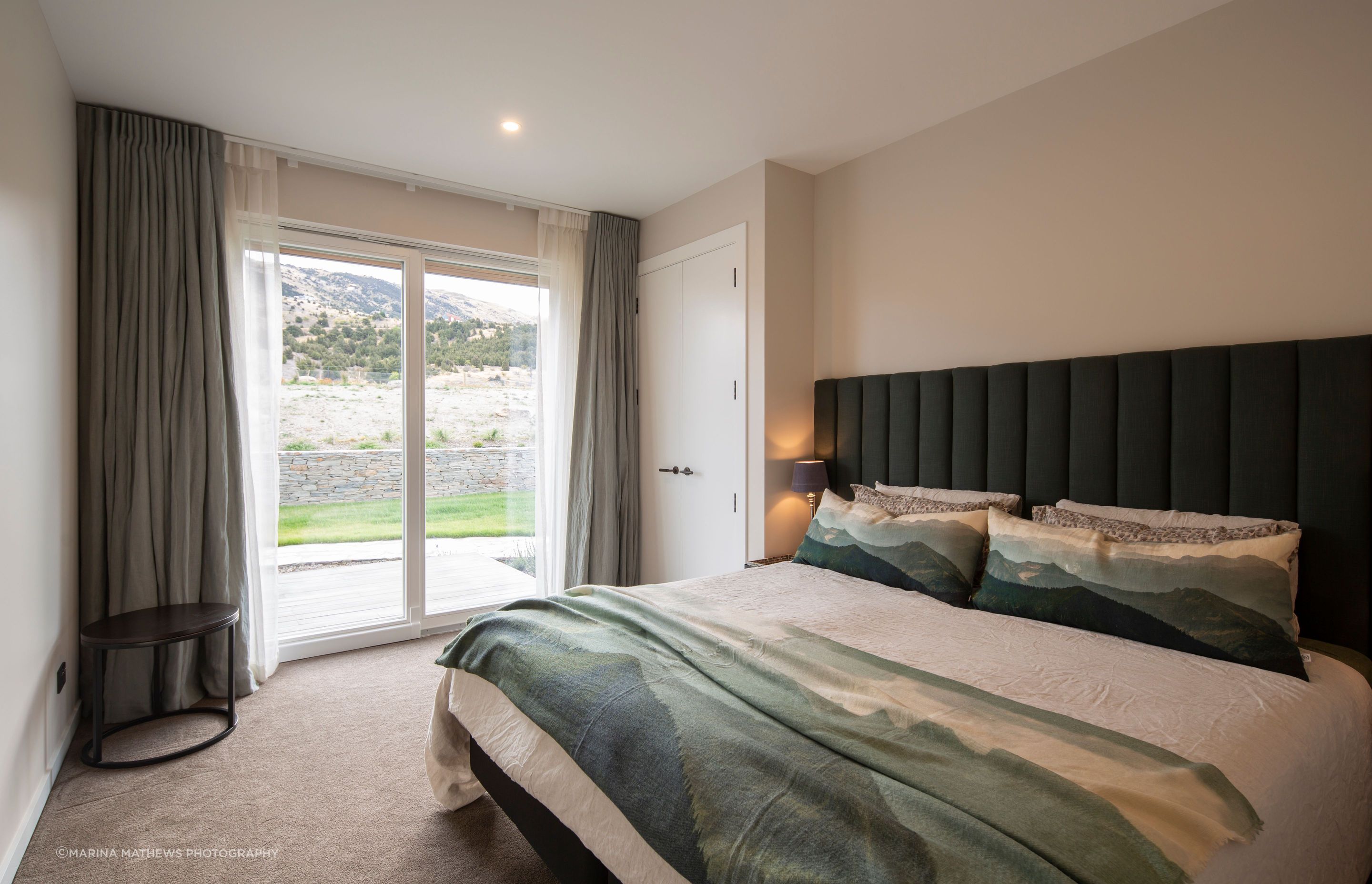 A comfortable guest bedroom takes in the colours of the environment.