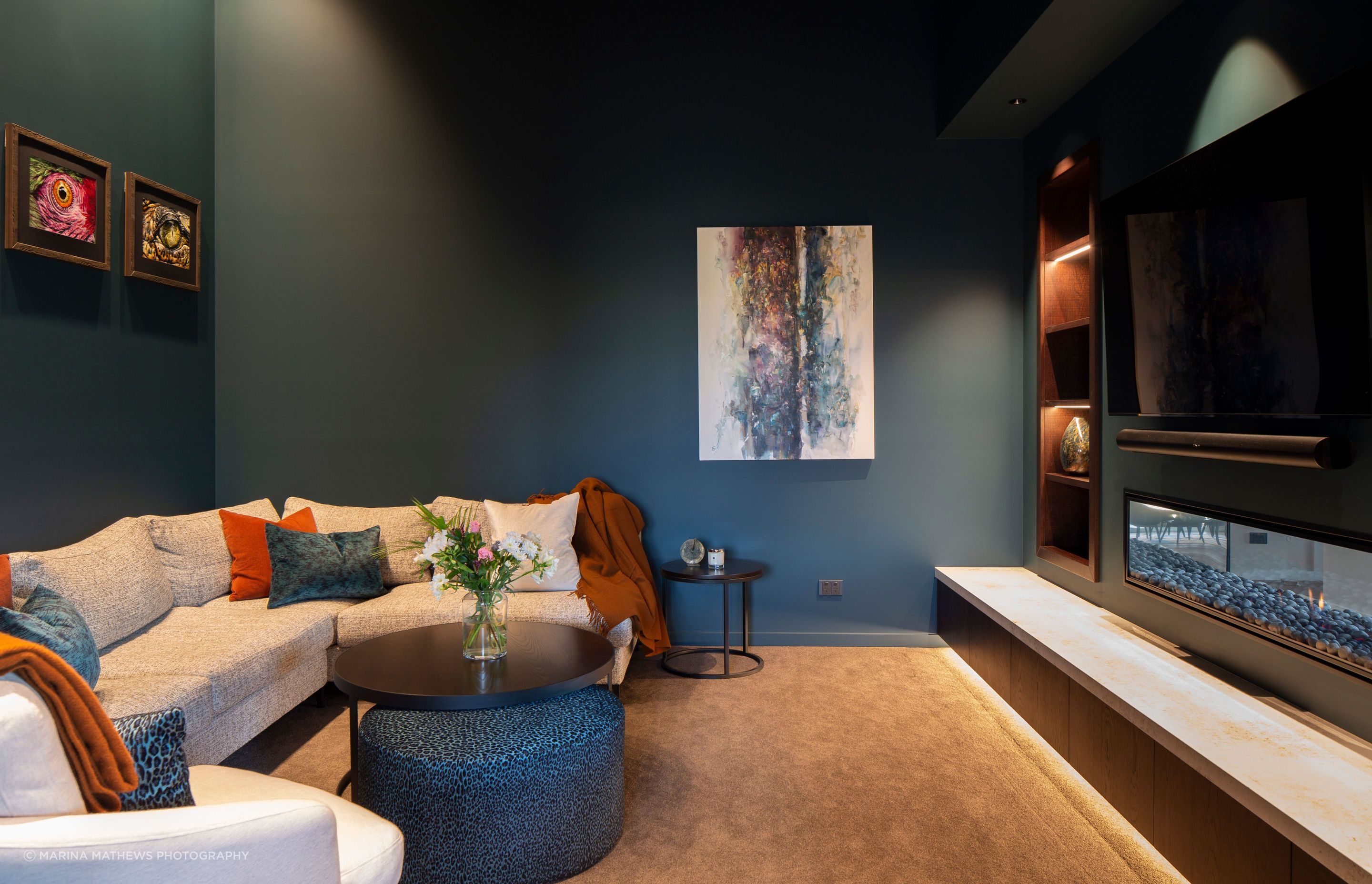 On the other side of the fireplace, the media room is the perfect nook to watch a movie.