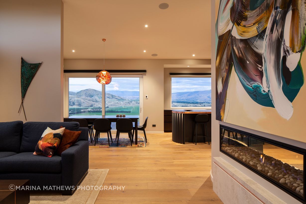 On one side of the gas fireplace the lounge offers a cosy retreat.