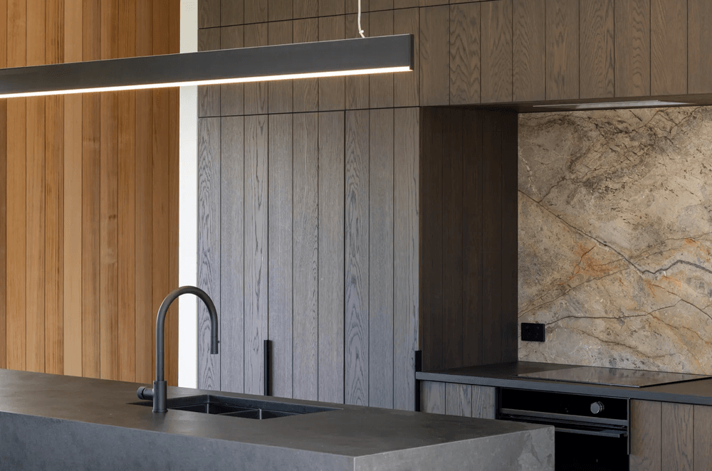 DBJ’s craftsmanship can be appreciated throughout the home, and specifically in the kitchen, where the dark chocolate brown cabinetry is more a piece of art.