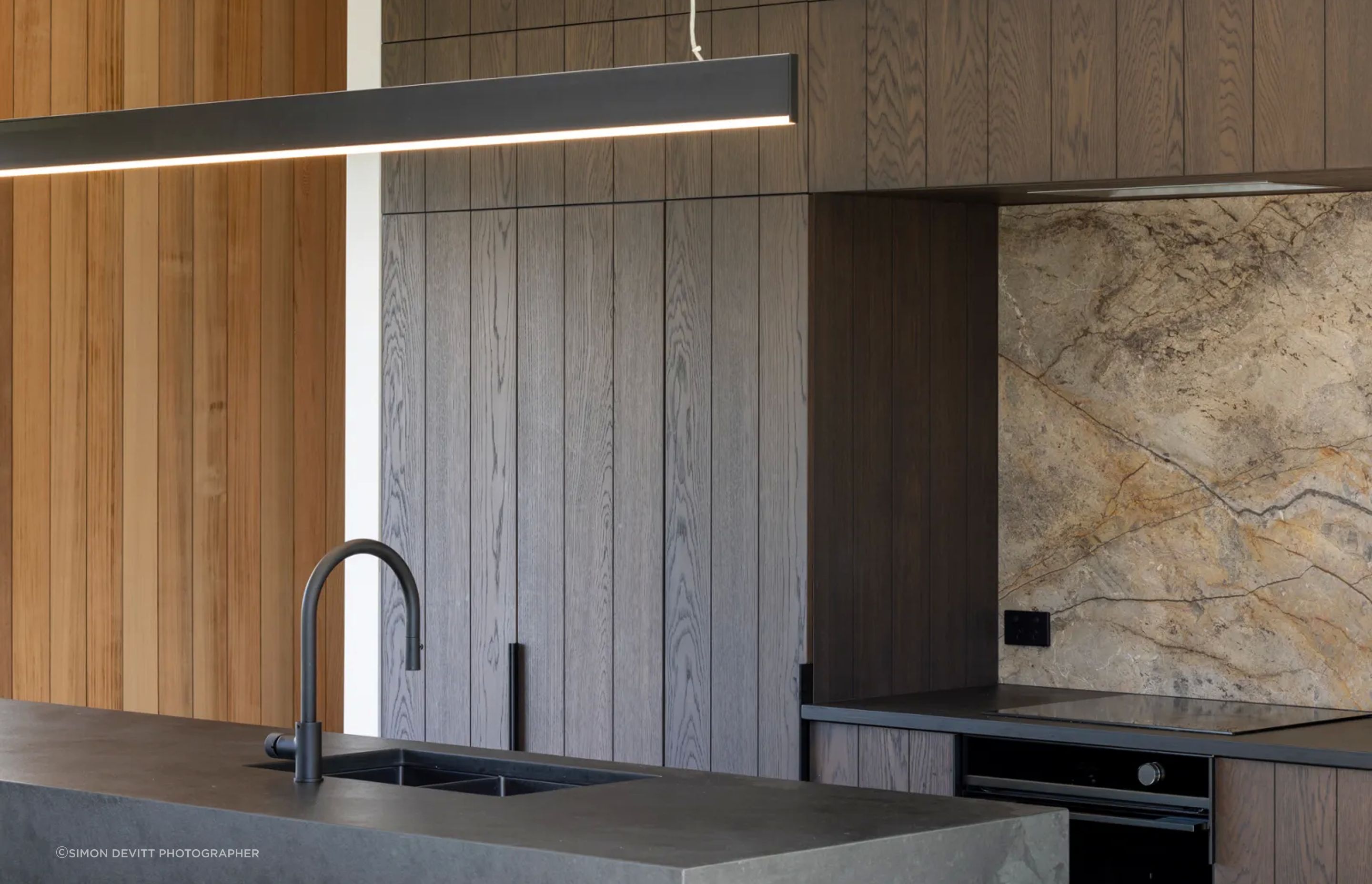 DBJ’s craftsmanship can be appreciated throughout the home, and specifically in the kitchen, where the dark chocolate brown cabinetry is more a piece of art.
