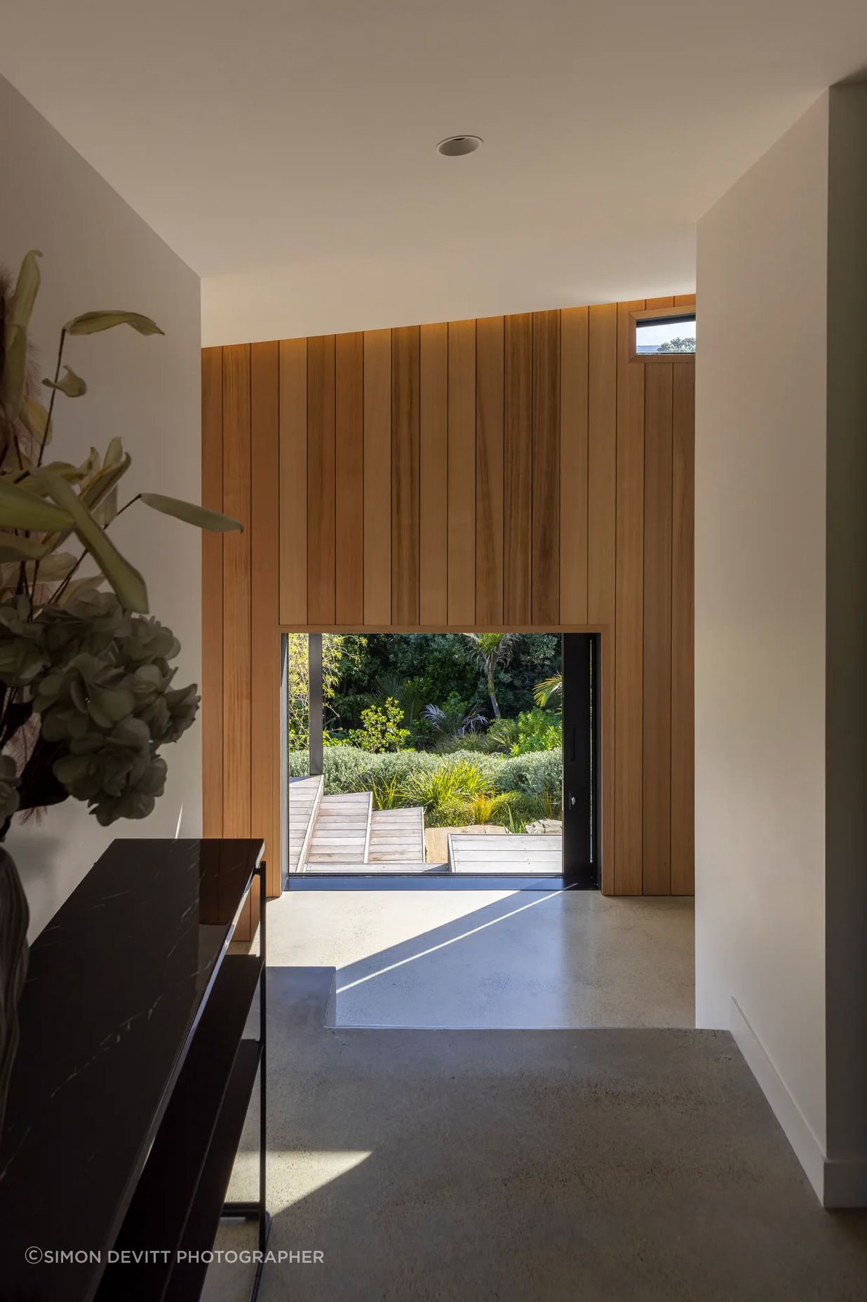 The home’s formal entry offers a direct sightline through to the south garden.