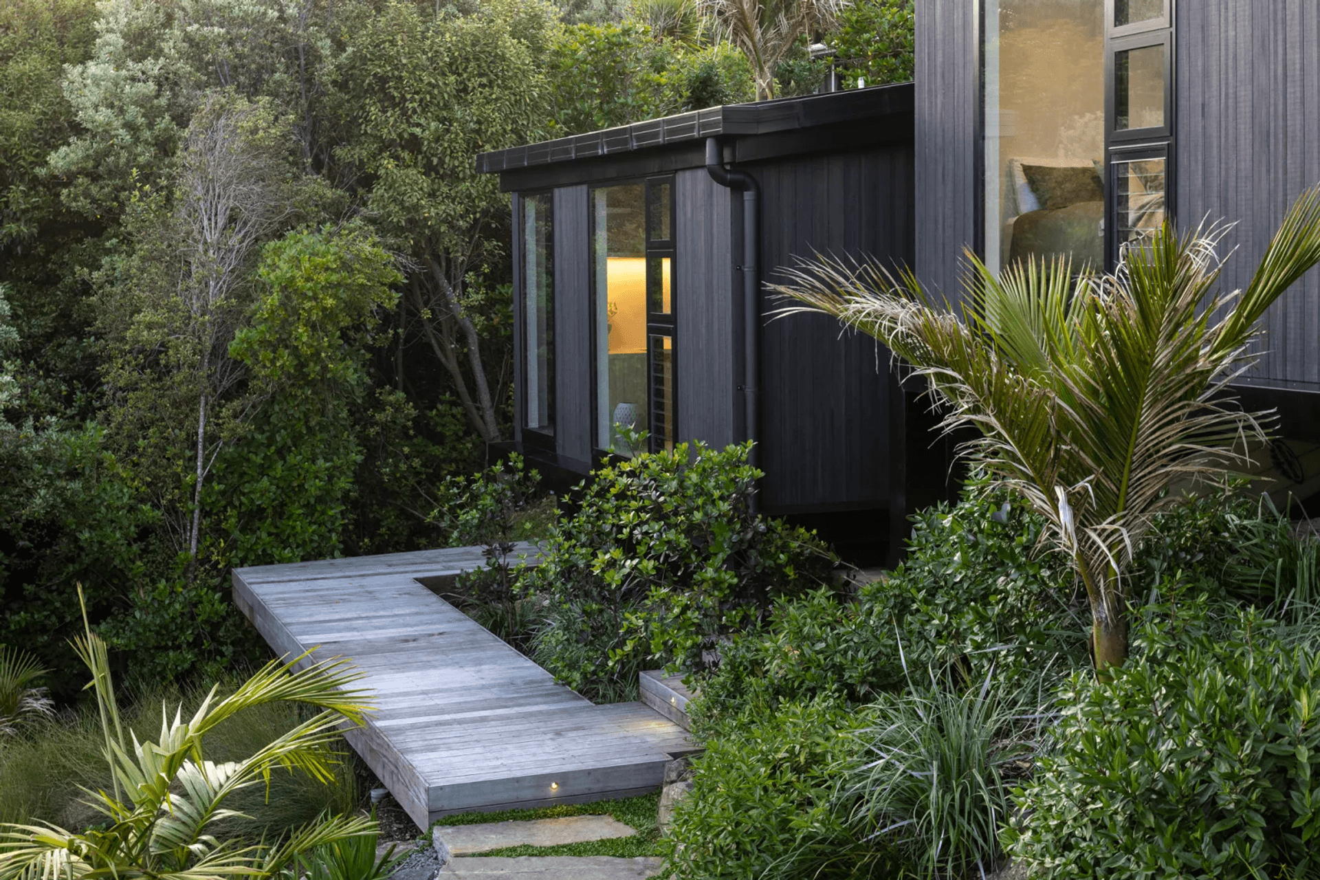 The master suite, a step down from the bedroom wing and secluded within nature.