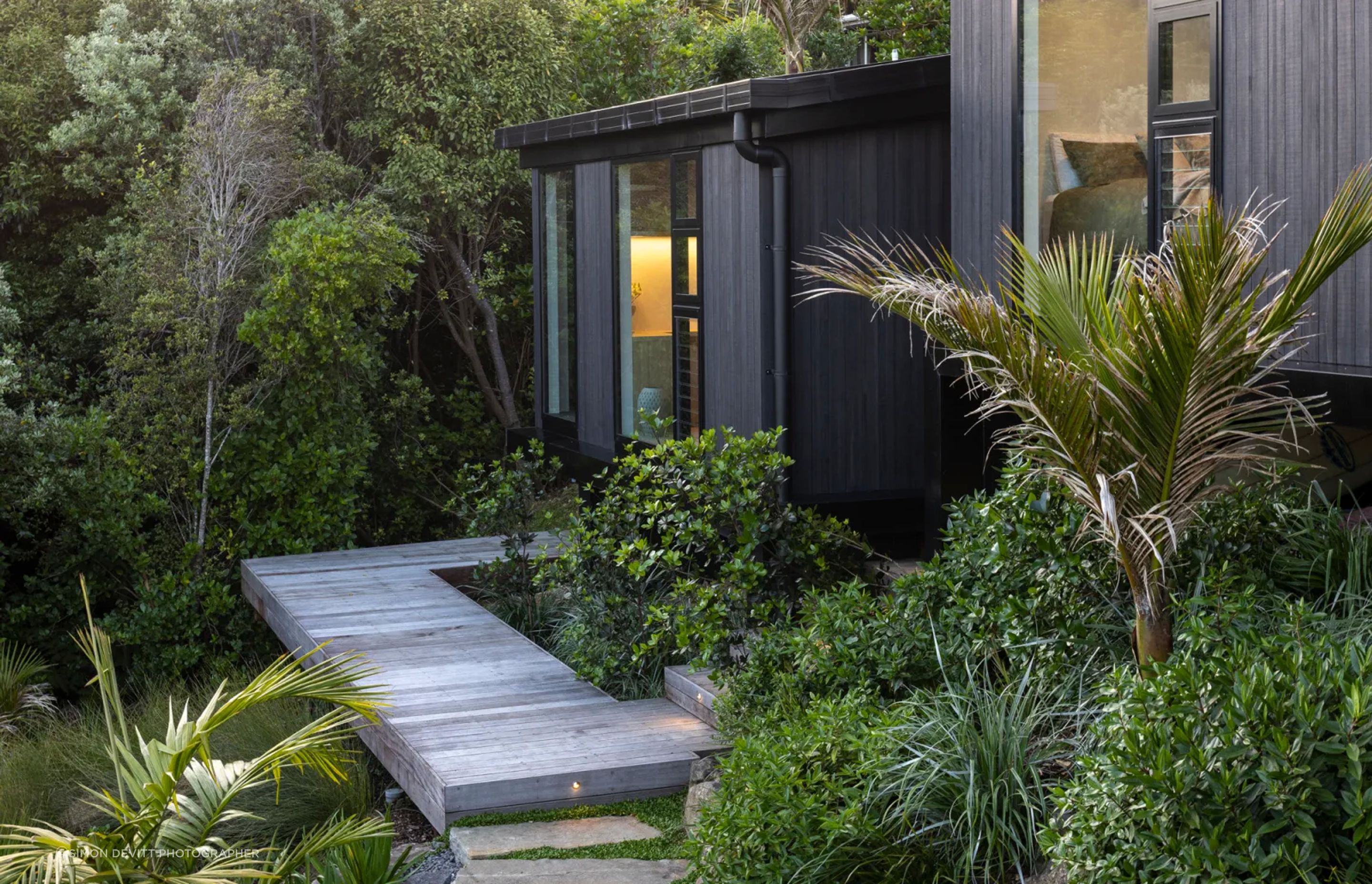 The master suite, a step down from the bedroom wing and secluded within nature.