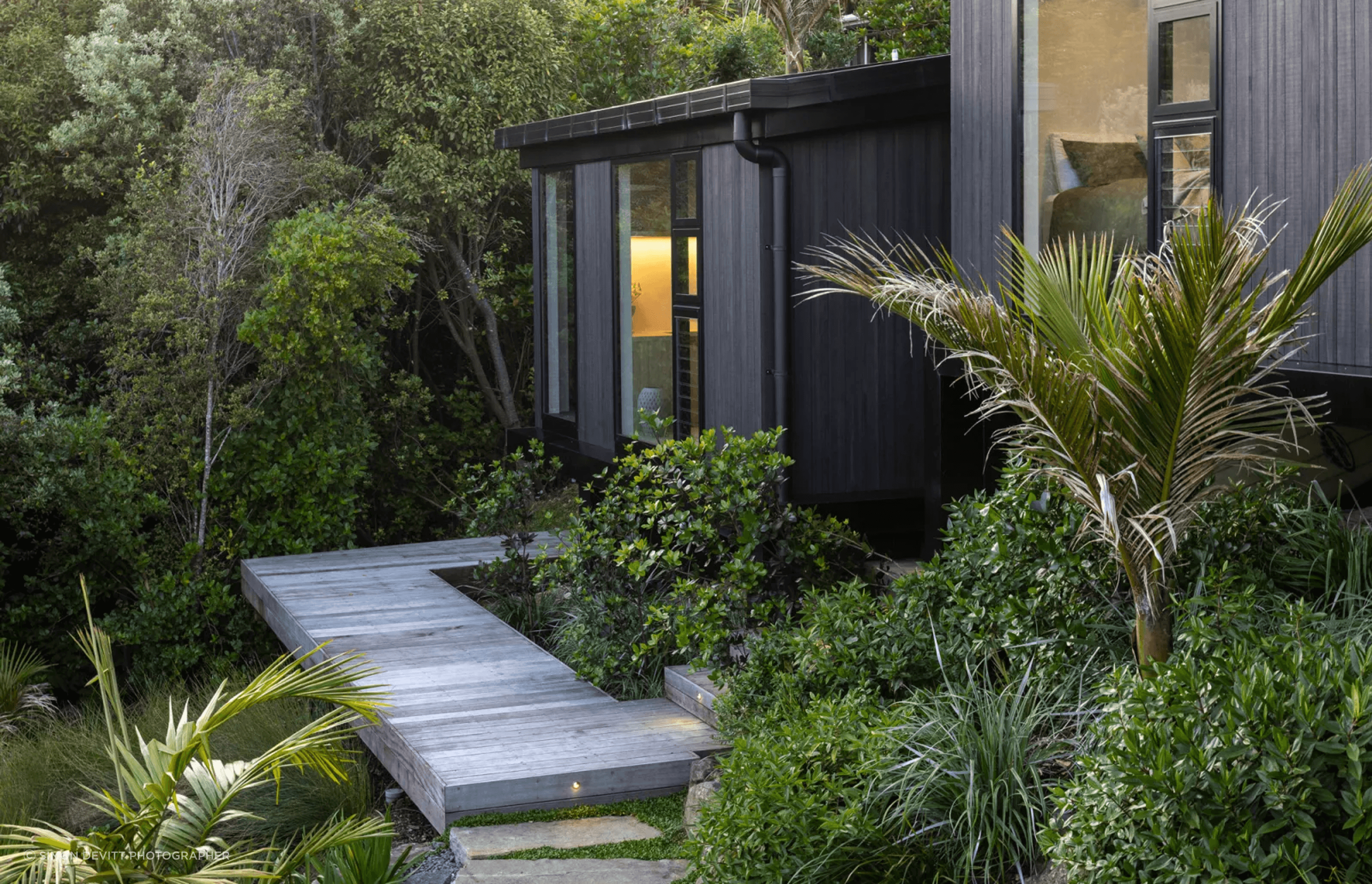 The master suite, a step down from the bedroom wing and secluded within nature.