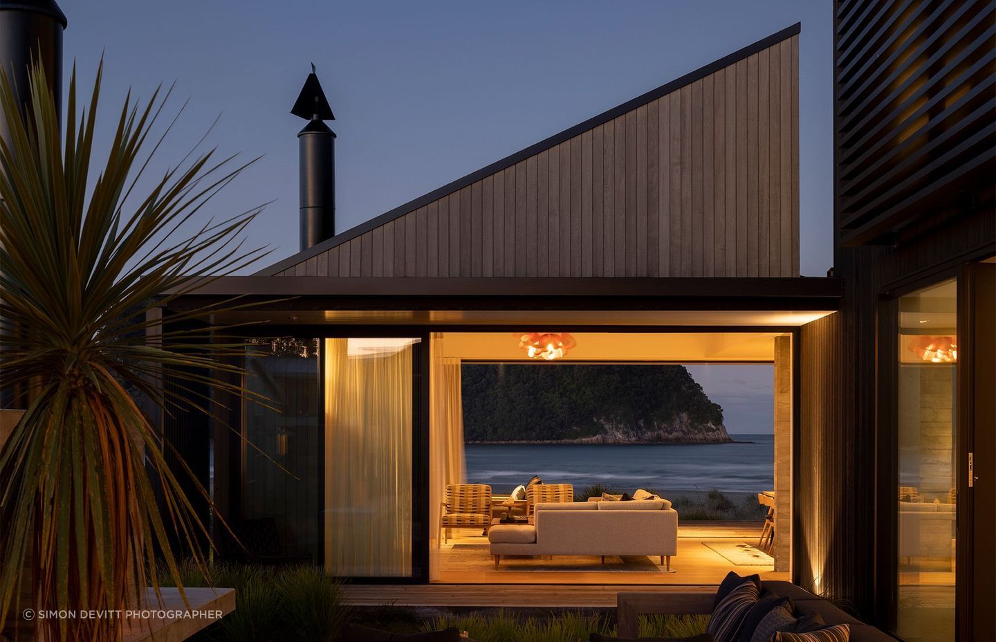 The main gabled form visually shifts at different elevational angles.