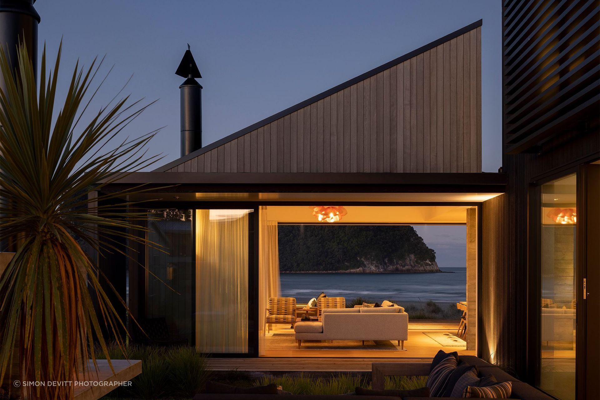 The main gabled form visually shifts at different elevational angles.